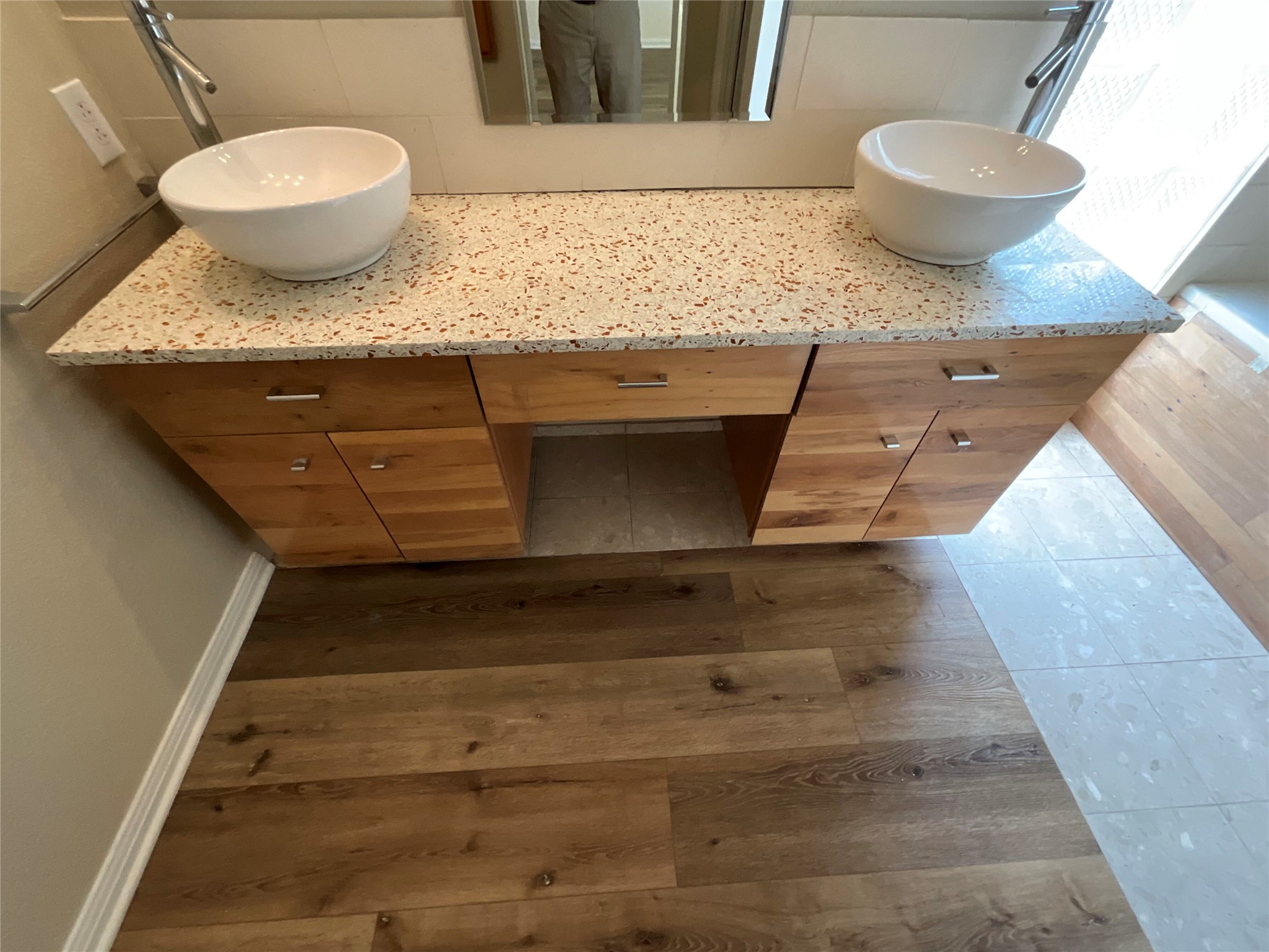 15702 Racine Cove Austin, TX 78717 - Photo 21 of 27 Double vessel sinks atop a modern vanity create a focal point in this well-appointed bathroom.