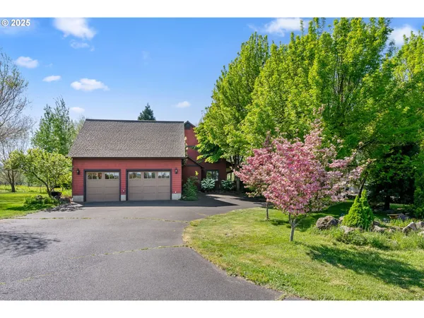 a view of a house with a yard and garage