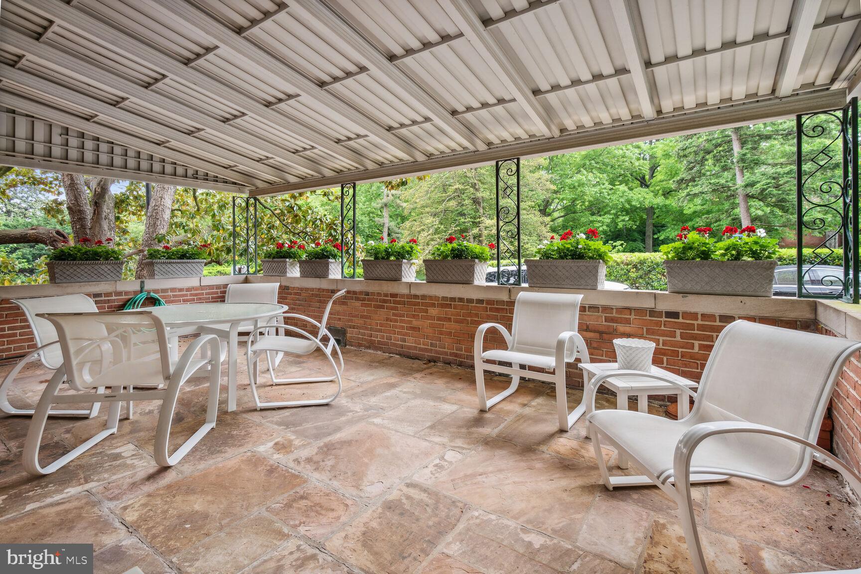 a view of a patio with chairs and backyard