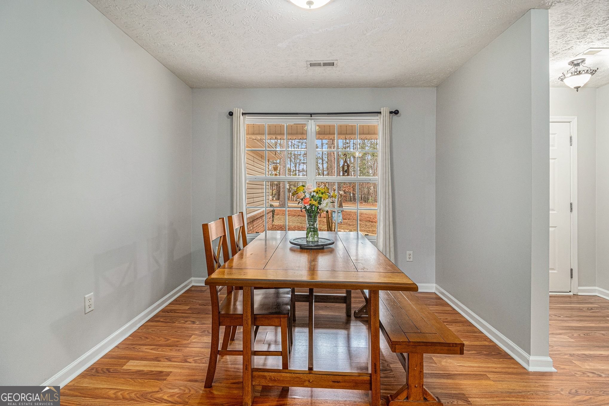 30 Old Mill Way Senoia, GA 30276 - Photo 11 of 29 a view of a dining room with furniture window and wooden floor