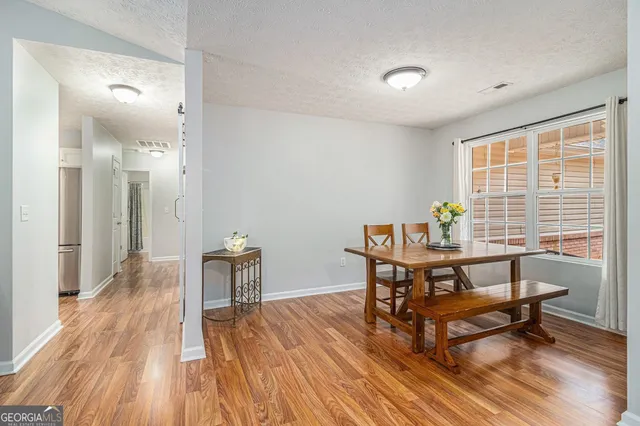a view of a room with wooden floor and furniture