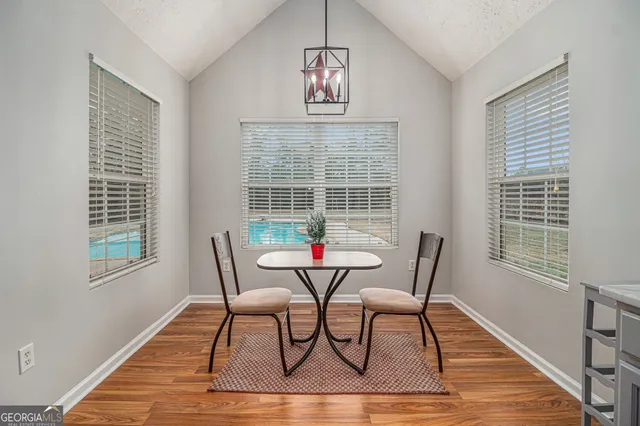 a view of a dining room with furniture window and wooden floor