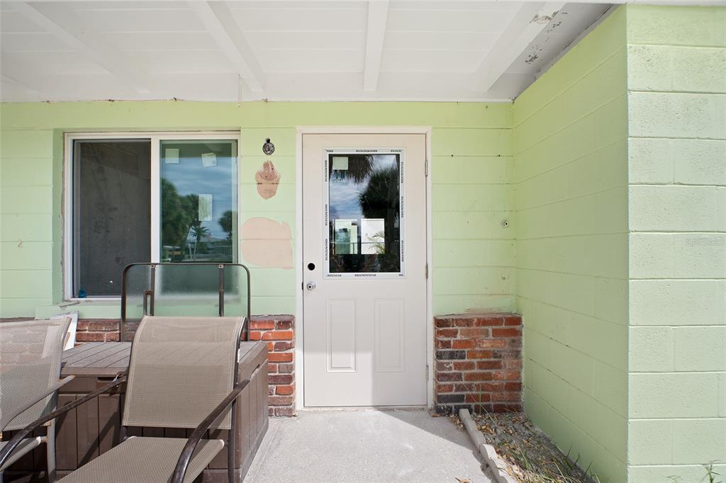 1385 Gulf Boulevard, Unit 10 Englewood, FL 34223 - Photo 4 of 36 a backyard of a house with outdoor seating