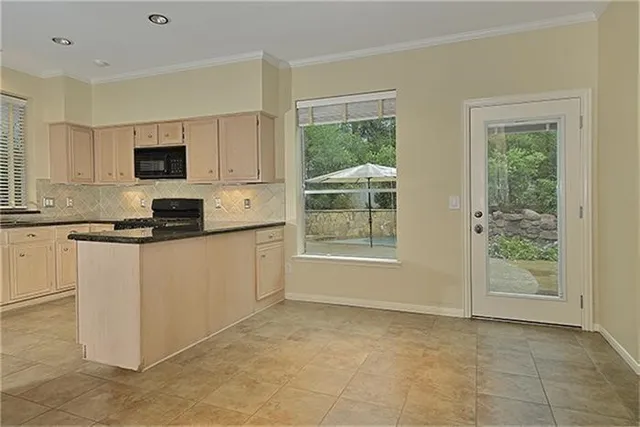 a kitchen with a stove top oven sink and cabinets