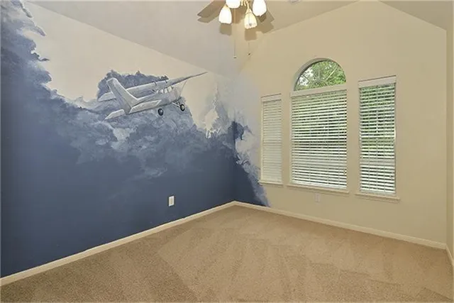 a view of a livingroom with an empty space and a window