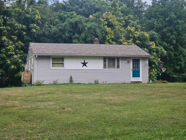 a front view of a house with a garden
