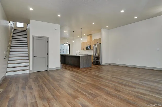 a view of a kitchen with wooden floor and a kitchen