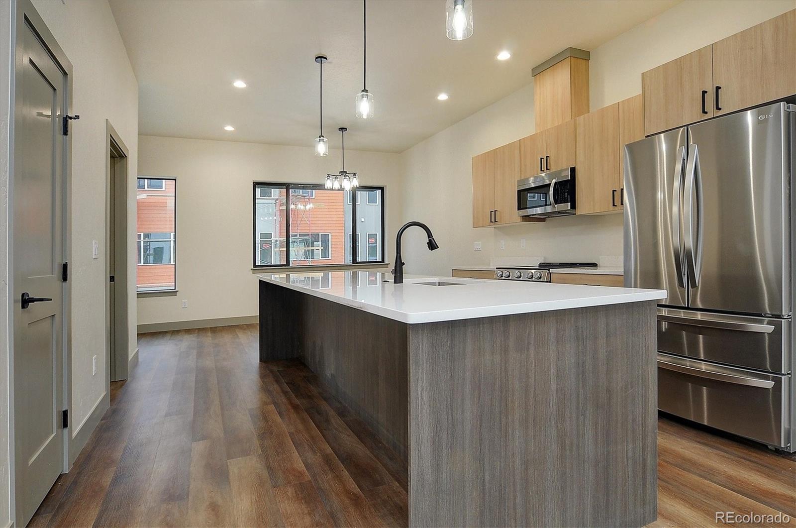 6398 Cleora Road, Unit G Salida, CO 81201 - Photo 10 of 34 a kitchen with kitchen island a sink stainless steel appliances and cabinets