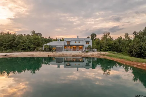 a view of a lake with a houses in the back