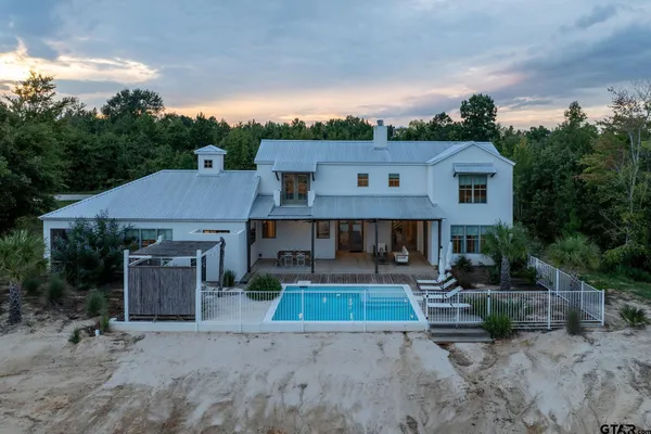 a bedroom with a bed couch and a window