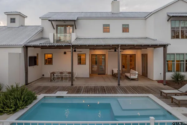 a bedroom with a bed and a couch next to a window