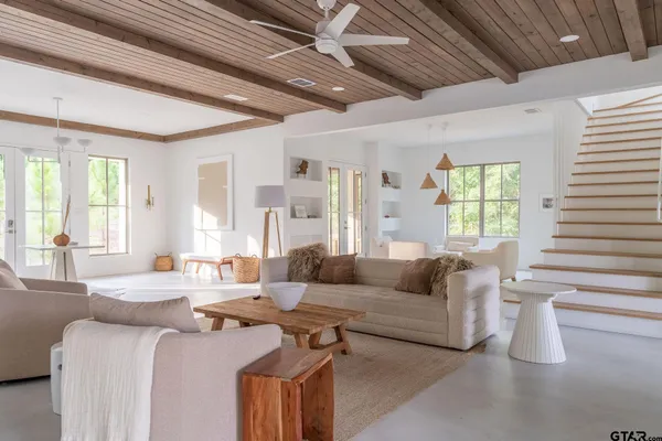a living room with fireplace furniture and a large window