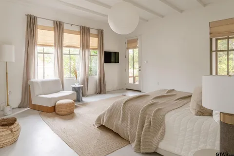 a bedroom with a bed couch and a window