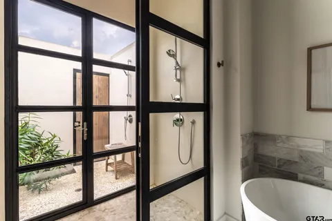 a bathroom with a bathtub and window