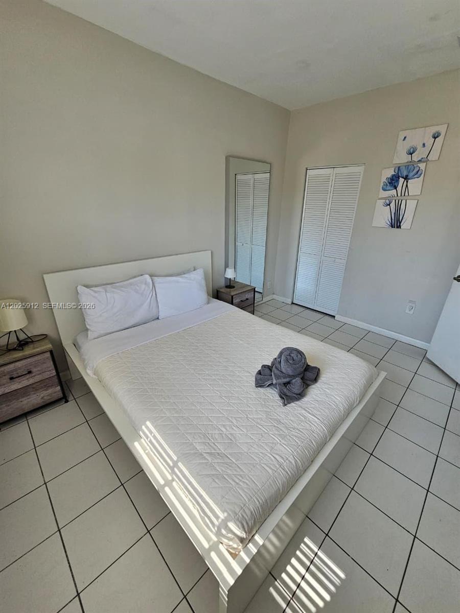 2224 Southwest 11th Street, Unit 3 Miami, FL 33135 - Photo 8 of 15 a bedroom with a bed and a window