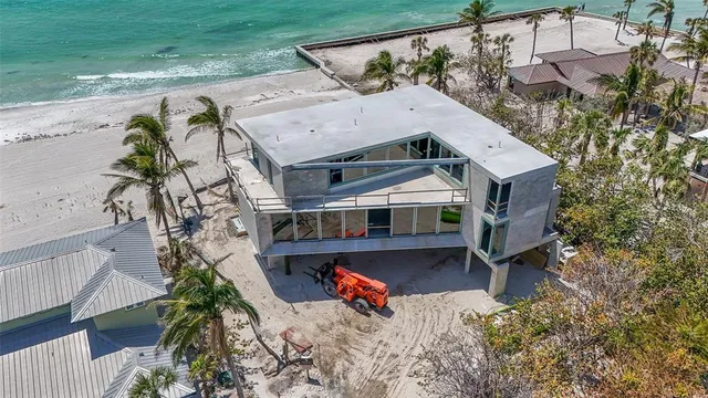 an aerial view of a house with a yard