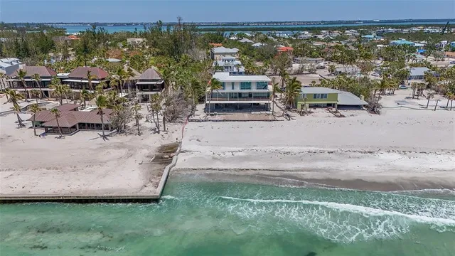 an aerial view of a house with a yard and lake view