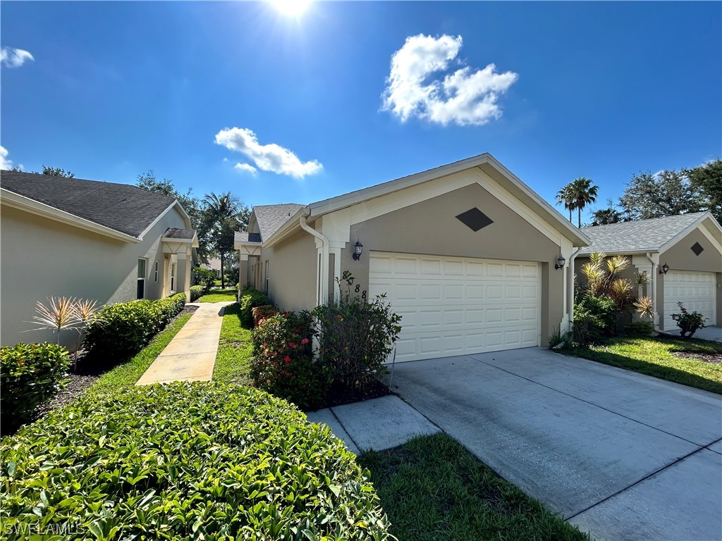 a front view of a house with a yard and a garage