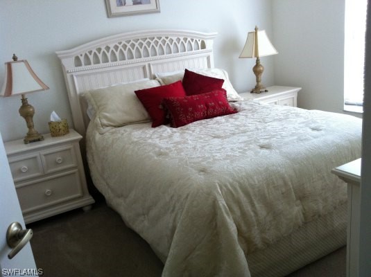 8088 Ibis Cove Circle, Unit 804 Naples, FL 34119 - Photo 12 of 27 a bedroom with a bed and a cabinets