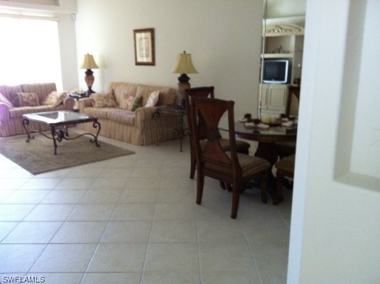 8088 Ibis Cove Circle, Unit 804 Naples, FL 34119 - Photo 13 of 27 a living room with furniture and a window
