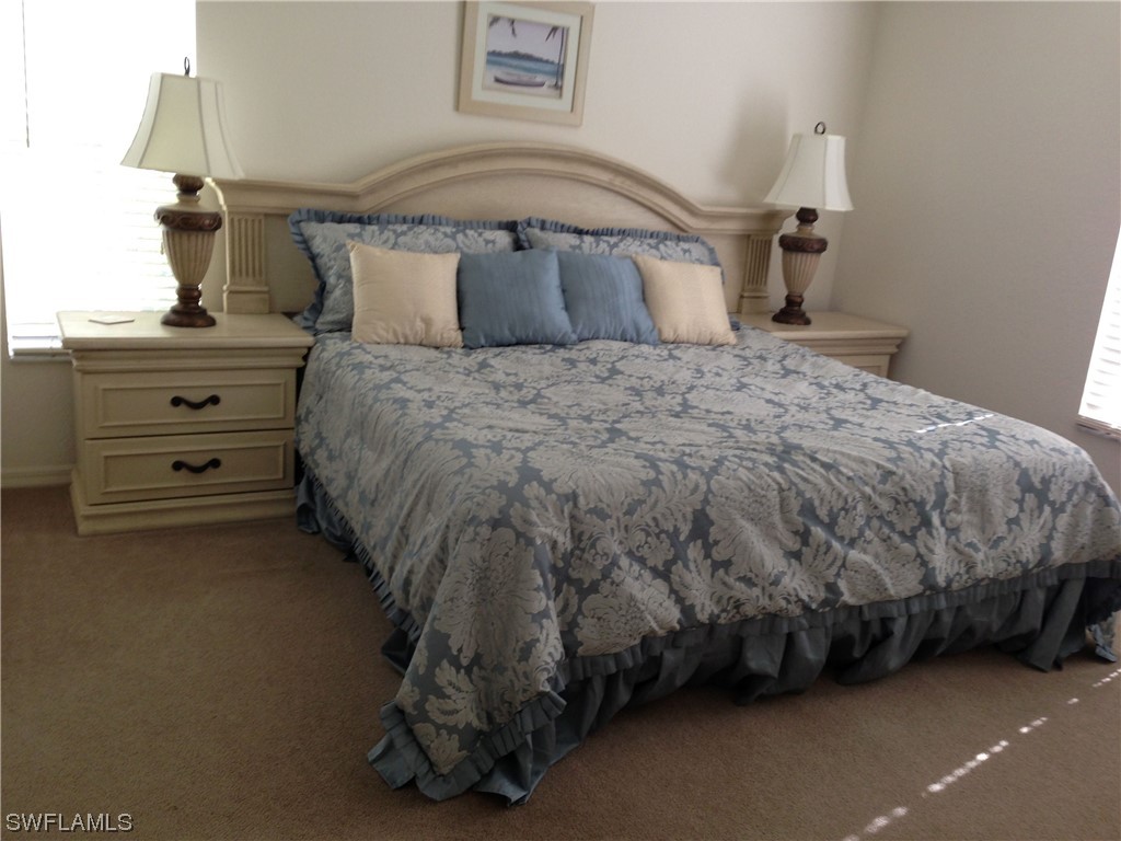 8088 Ibis Cove Circle, Unit 804 Naples, FL 34119 - Photo 17 of 27 a bedroom with a bed and a window