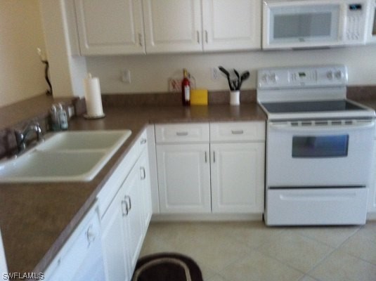 8088 Ibis Cove Circle, Unit 804 Naples, FL 34119 - Photo 19 of 27 a kitchen with granite countertop a sink stove and cabinets