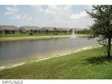 8088 Ibis Cove Circle, Unit 804 Naples, FL 34119 - Photo 25 of 27 a view of a lake with houses in the back
