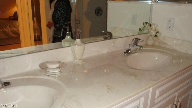 8088 Ibis Cove Circle, Unit 804 Naples, FL 34119 - Photo 4 of 27 a bathroom with a sink and a tub