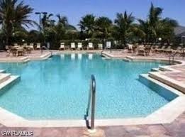 8088 Ibis Cove Circle, Unit 804 Naples, FL 34119 - Photo 9 of 27 a view of a lake with outdoor space