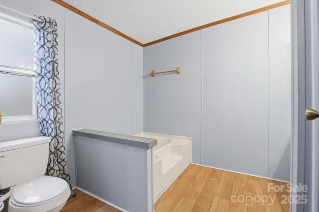 a white toilet sitting next to a shower curtain