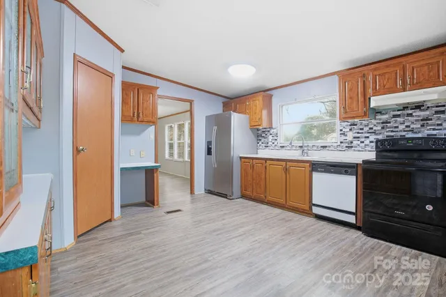 a kitchen with stainless steel appliances granite countertop a stove and a refrigerator