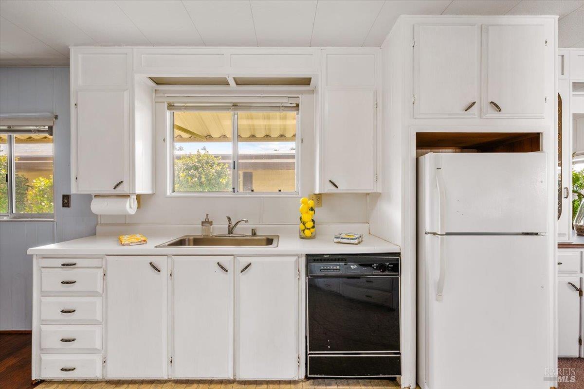 243 Parque Cabana Rohnert Park, CA 94928 - Photo 14 of 26 a kitchen with stainless steel appliances a refrigerator sink and cabinets