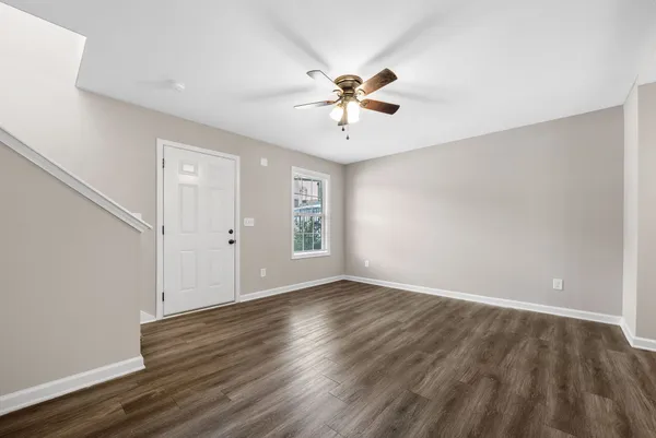 a view of an empty room with wooden floor