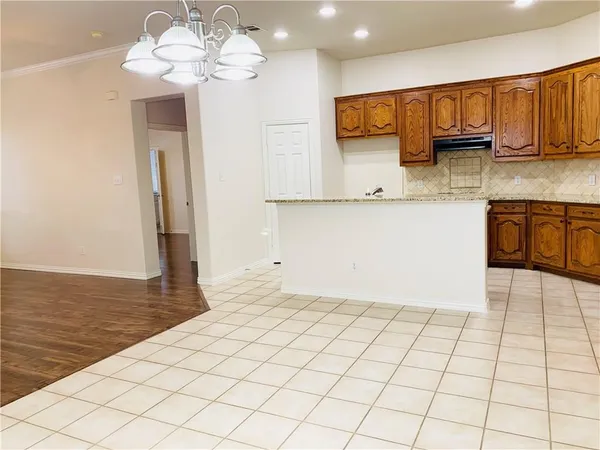 a view of kitchen with granite countertop cabinets