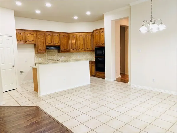 a view of a kitchen with a sink and cabinets