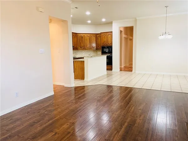 a view of kitchen with cabinets and wooden floor