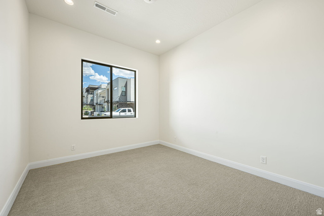 684 West High Tide Place, Unit 131 St. George, UT 84790 - Photo 4 of 27 Neutral-toned room with light beige carpeting and white baseboards