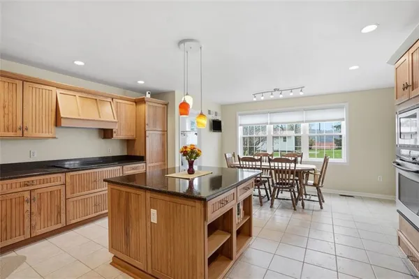 a kitchen with kitchen island granite countertop a sink and counter space