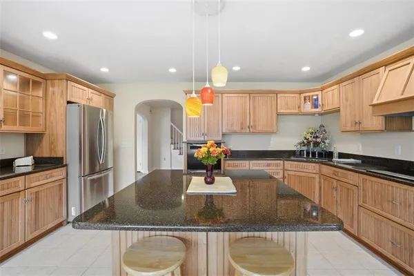 a kitchen with kitchen island a sink appliances and cabinets