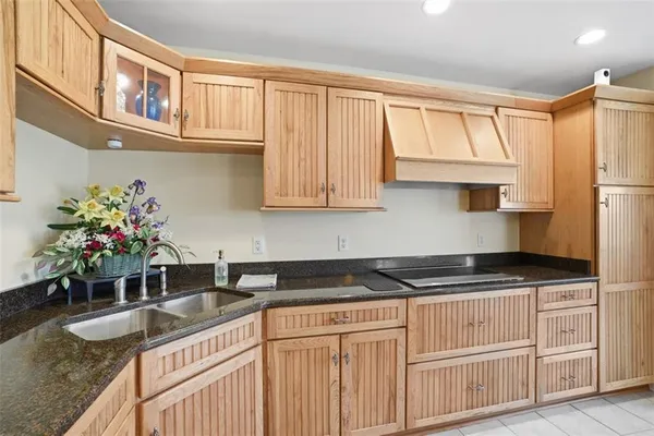 a kitchen with stainless steel appliances granite countertop a sink a stove and cabinets