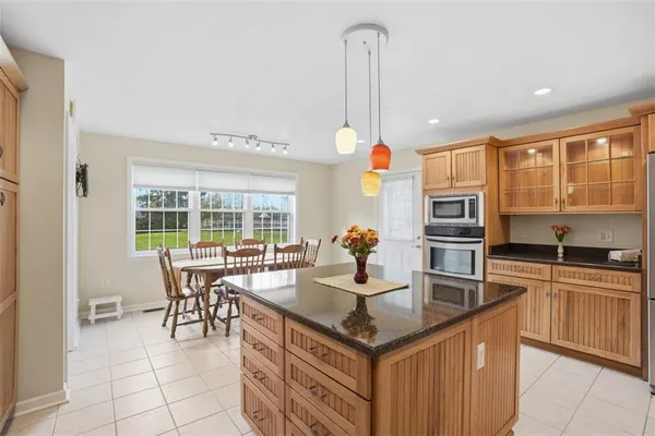 a kitchen with stainless steel appliances granite countertop a sink and a refrigerator