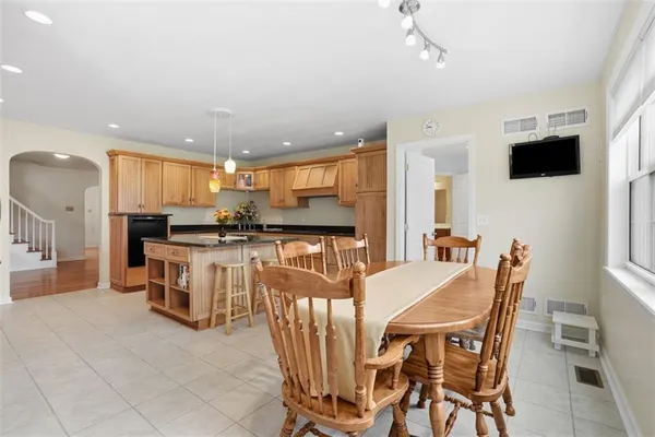 a view of a dining room with furniture and a kitchen