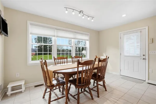 a view of a dining room with furniture window and outside view