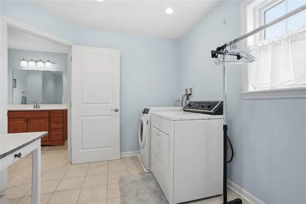 a utility room with cabinets washer and dryer