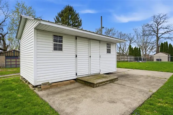 a view of a house with a yard and sitting area