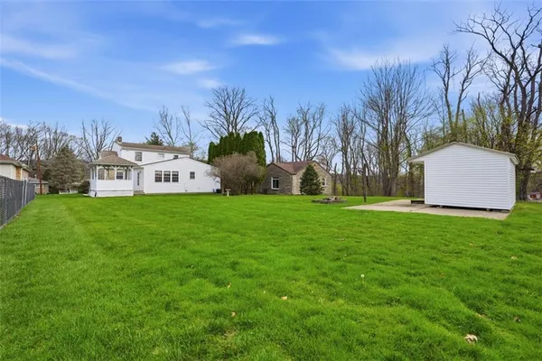 a view of a house with a backyard