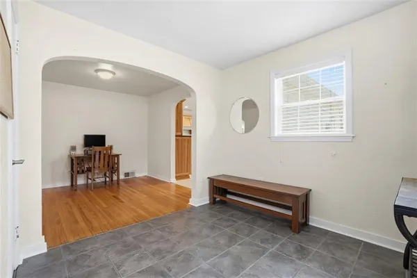 a room with furniture pool table and a window