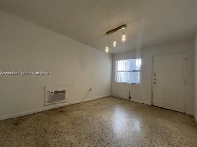 142 Southwest 18th Avenue, Unit 20 Miami, FL 33135 - Photo 3 of 8 an empty room with chandelier fan and windows