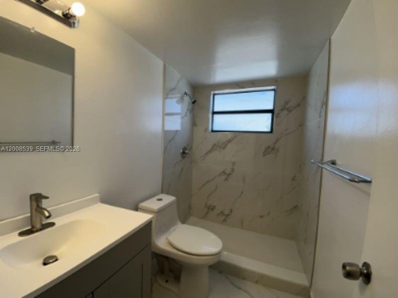 142 Southwest 18th Avenue, Unit 20 Miami, FL 33135 - Photo 7 of 8 a bathroom with a sink a toilet and shower