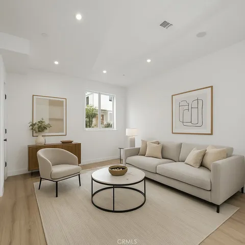 a living room with furniture and a potted plant